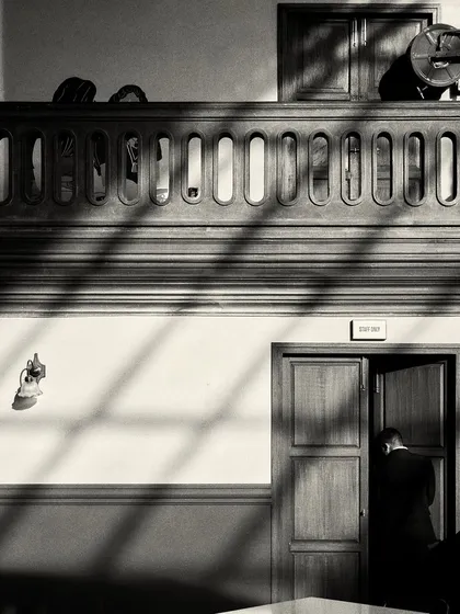 Shadows from the windows fall across the wall and floor, creating graphic patterns that change throughout the day.