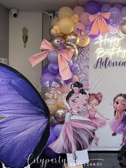 A shot of the ballerina and butterfly setup, focusing on the large butterfly wing prop and character standee.