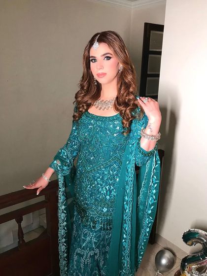 Another angle of the client's curly hairstyle, showing how it falls beautifully over her shoulders. This is a classic party hairstyle that never goes out of style.