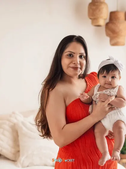 A beautiful mother-daughter portrait in my boho studio. The contrast of the mother's vibrant red dress and the baby's white outfit is just lovely.