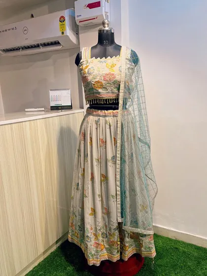 The complete look of the lightweight grey lehenga with leaf embroidery. It comes with a contrasting light blue net dupatta for a soft pop of color.