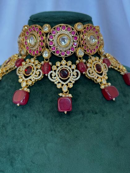 A close-up of the choker set with deep red stones. The intricate design makes this a beautiful rental piece for any celebration.