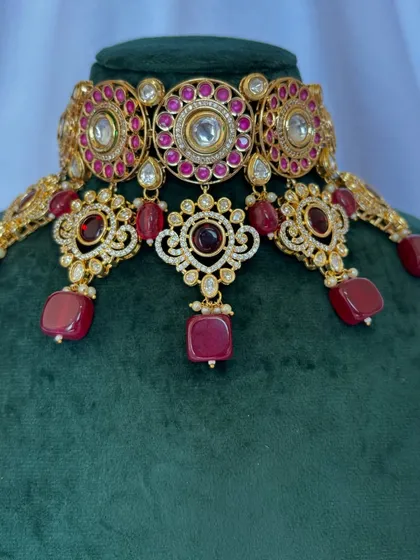 A close-up of the choker set with deep red stones. The intricate design makes this a beautiful rental piece for any celebration.