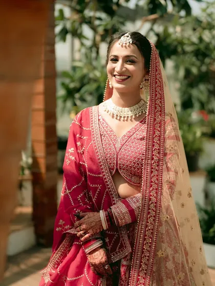 A radiant bride, smiling in the warm sunlight. This portrait captures her natural beauty and the joy of her wedding day.