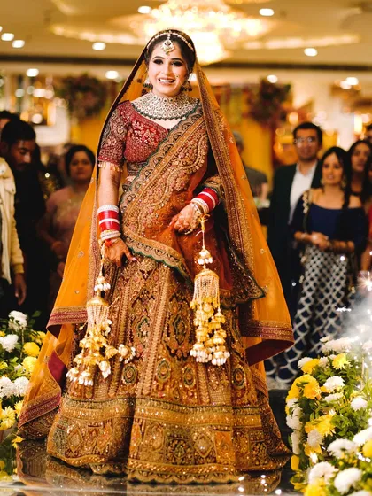 The bridal entry is a breathtaking moment. I make sure to capture the bride in all her glory, focusing on the beautiful attire, the happy smile, and the grand scale of her walk down the aisle.