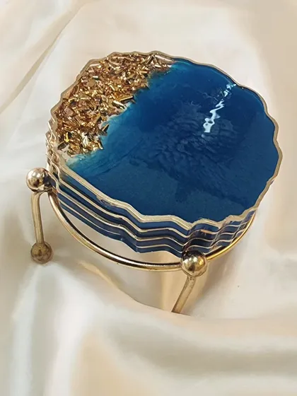Another view of the blue and gold coaster set, stacked and ready to go with its metal stand.