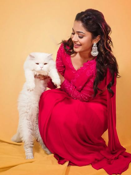 A fun, candid moment during the shoot for the 'Prasanna Vadanam' trailer release. The vibrant pink pre-draped saree was chosen to be bold, youthful, and memorable.