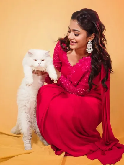 A fun, candid moment during the shoot for the 'Prasanna Vadanam' trailer release. The vibrant pink pre-draped saree was chosen to be bold, youthful, and memorable.