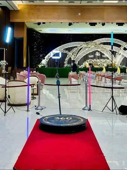 A wider view of my 360 photo booth setup at a large wedding reception. The setup is designed to look professional and inviting, fitting seamlessly into the elegant decor of the venue while providing endless entertainment.