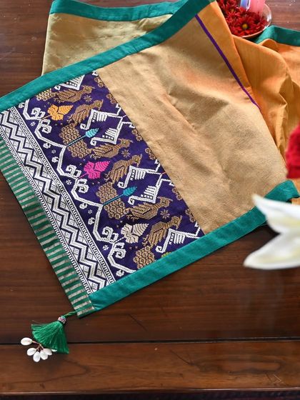 Another detail shot of the peacock motif runner, showing the fine weaving and the simple, elegant tassels.