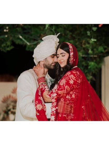 An intimate wedding portrait of the couple. The groom's gentle touch and their close embrace create a moment of quiet love and connection.