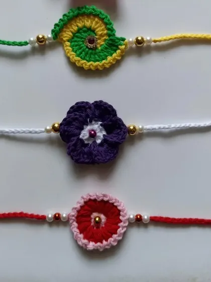 A collection of colorful floral and spiral crochet rakhis. Each one is handcrafted and can be customized in your favorite colors.