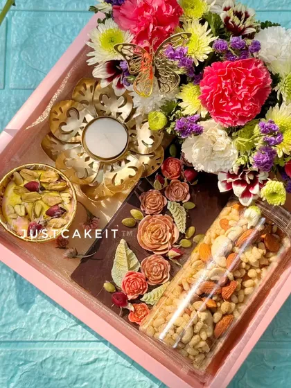An angled view of the 'Festive Bloom' hamper, showing how all the elements come together. The combination of edible treats and fresh flowers makes it a complete and thoughtful gift.