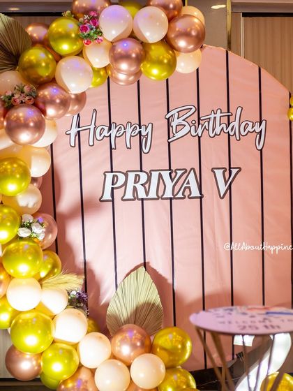 A close-up of the personalized backdrop and balloon arrangement, showing the mix of colors and textures.