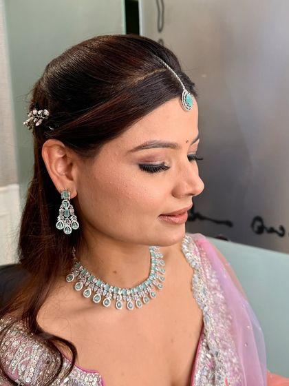 A close-up profile shot that focuses on the eye makeup and flawless skin. The subtle winged liner and soft eyeshadow create a sophisticated look that is perfect for photography.