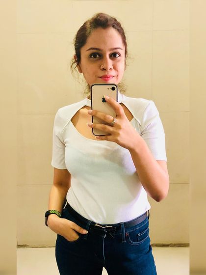 Basics are the foundation of a great wardrobe. This white tee with a unique scoop neckline adds a modern twist to a classic piece, pairing perfectly with dark blue denims for a clean, summery look.