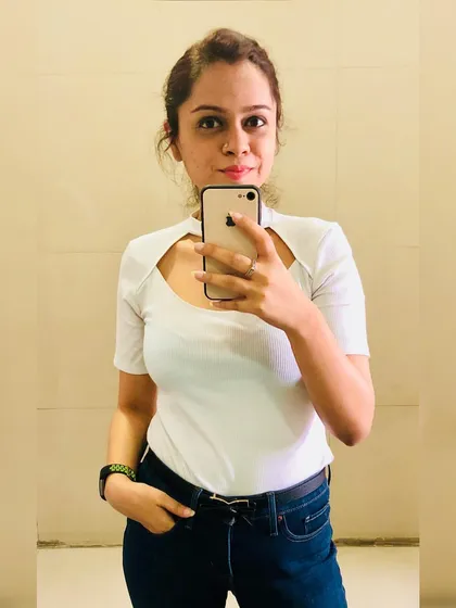 Basics are the foundation of a great wardrobe. This white tee with a unique scoop neckline adds a modern twist to a classic piece, pairing perfectly with dark blue denims for a clean, summery look.