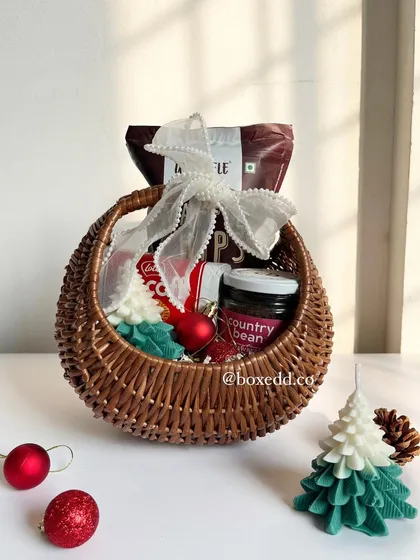 A charming Christmas and New Year goodie basket. This wicker basket is filled with treats and holiday-themed items, perfect for a warm, rustic-style gift.