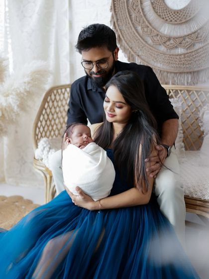 A complete family portrait, filled with warmth and love. The bohemian studio setup with natural textures provides a beautiful backdrop for these precious memories.
