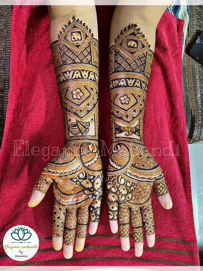 This custom bridal mehendi includes unique elements like a mortar and pestle, representing the couple's story, along with elephants and floral patterns.