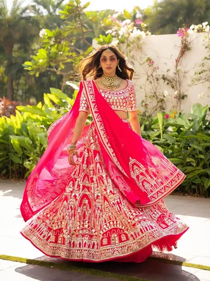 A full-length shot showcasing the vibrant pink lehenga and the glowing makeup. The look is designed to be cohesive and stunning from head to toe, perfect for a grand Mehendi celebration.