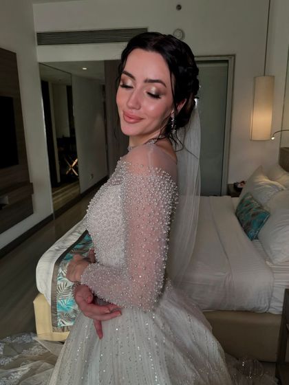 A close-up of her serene expression and the delicate details of her makeup and hair.