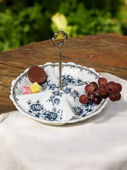 A simple yet elegant serving platter with partitioned sections, decorated in classic blue pottery style. It's a versatile piece for serving different snacks or appetizers during a gathering.