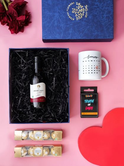 A flat lay of the hamper with the calendar mug, which can be personalized to mark a special date for the couple.