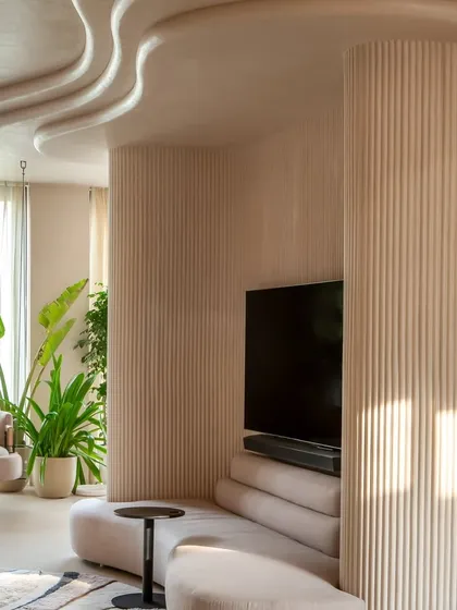 Light plays beautifully across the fluted pillar and wavy ceiling in this view of the "Marshmallow" penthouse. We turned structural elements into sculptural features to maintain the home's fluid, organic aesthetic.