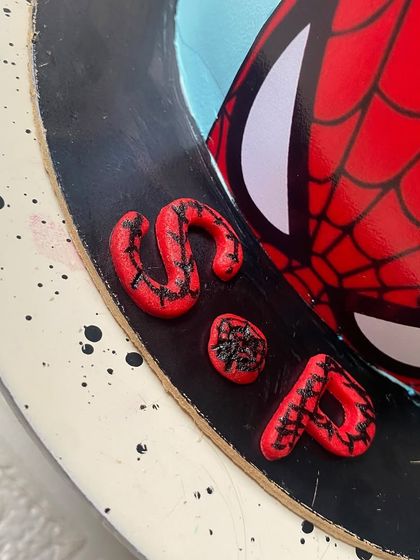 A close-up of the custom lettering on our Spiderman cake. Every hero deserves a super slice.