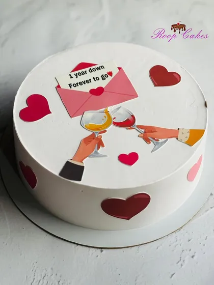 Cheers to one year down and forever to go. A sweet and simple anniversary cake with a modern, romantic design.