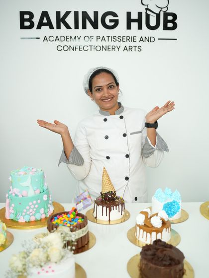 As an instructor, this is my proudest moment. Standing with the amazing variety of cakes our students created, from two-tier cakes to drip cakes, each one a testament to their hard work and newfound skills.