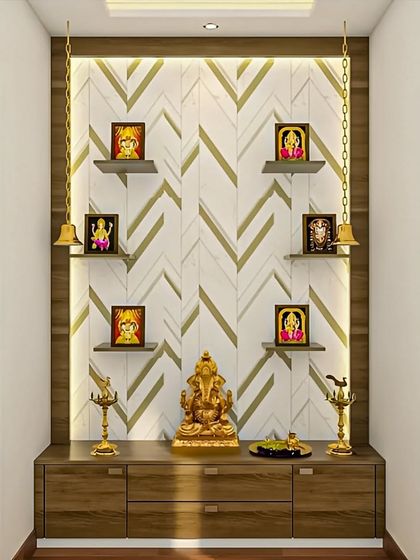 For a more minimalist approach, this pooja unit features a chevron-patterned accent wall with floating shelves for deities. The design is clean, elegant, and perfectly suited for a contemporary apartment.