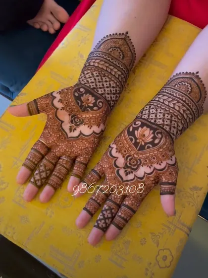 This design focuses on the lotus, a symbol of purity and beauty. The central lotus motif on the palm is surrounded by intricate jaali work and matching patterns on the fingers.