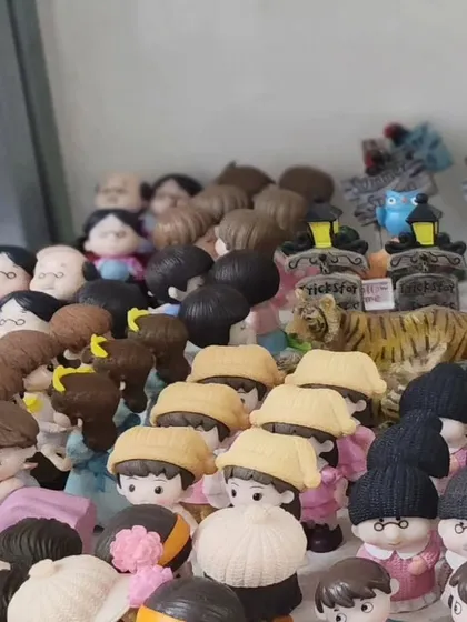 A close up of our detailed human figurines, including grandparents and children in hats. These small touches can bring your miniature garden to life.