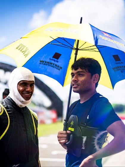 Two drivers debriefing after a session, sharing insights and strategies.