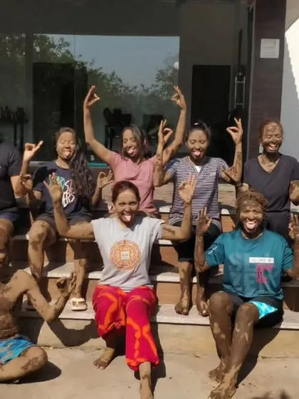 Our students doing Simhasana (Lion's Pose) while covered in mud during our Holi celebration.