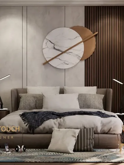 A view of the bed, which is set against a paneled wall with vertical wood slats. This adds texture and warmth, contrasting beautifully with the cool tones of the marble and glass used elsewhere in the room.