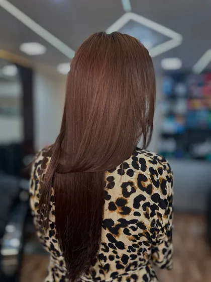 This shot highlights the healthy, smooth texture of the hair after our global color service.