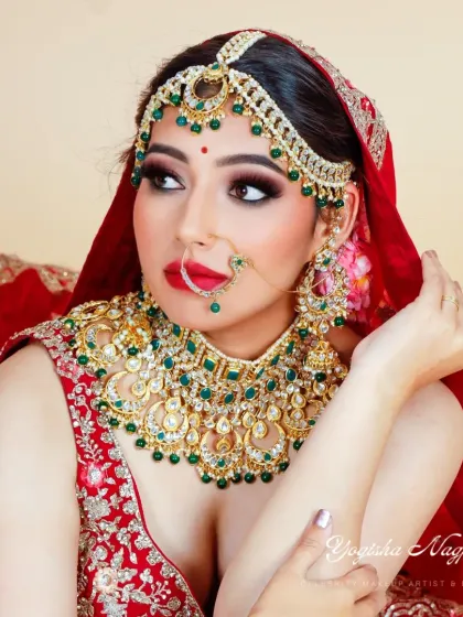 A close-up on the intricate details of this bridal makeup. Notice the perfectly blended eyeshadow and the sharp definition that makes the eyes pop, paired with a classic red lip for that ultimate bridal feel.