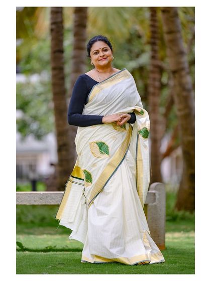 A classic, happy portrait of the model in the traditional Onam saree, perfect for festive branding.