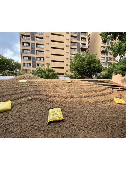 The beginning of the 'rising green'. This image shows the carport roof being prepared with soil, contoured and ready for the lawn to be laid. This is the foundational work for creating a sloping garden.