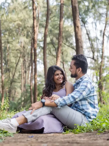 A candid, happy moment shared between the couple while sitting amidst the trees. These relaxed, unposed shots are perfect for telling your authentic love story.
