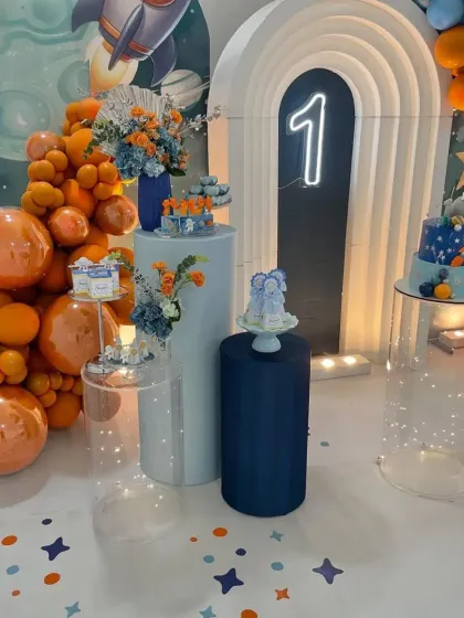 A wider view of the space party setup, showing the custom flooring with star decals and the arrangement of props and dessert stands.