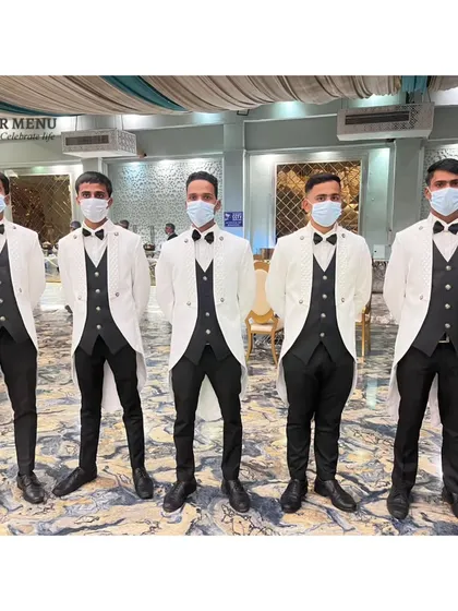 My professional service staff in crisp white and black uniforms, ready to provide impeccable service to your guests.
