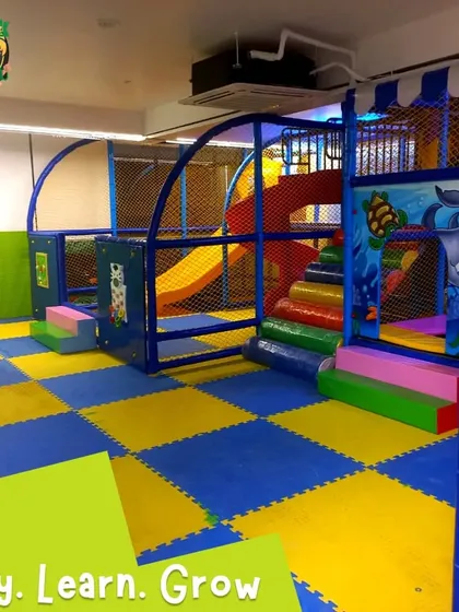 Another view of the expansive soft play area, highlighting the combination of slides, tunnels, and open play spaces all protected by netting.
