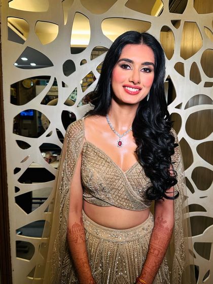 A bright, happy smile from a beautifully glammed-up wedding guest. The makeup is designed to last all night while looking radiant and joyful.