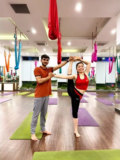 Another student mastering the Flag Pose with my support. This asana requires a combination of strength, flexibility, and trust.