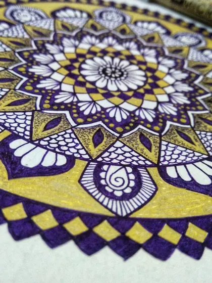 A detailed close-up of the violet and gold mandala as it's being created. I used a Micron pen for the violet details and a Uniball pen for the metallic gold, showing how different tools can be combined.
