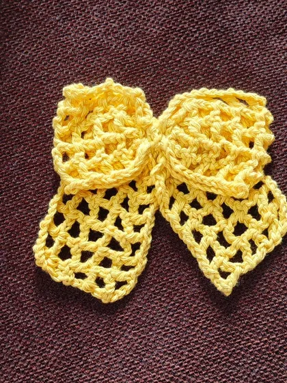 A single yellow lacy bow, showing the intricate and airy pattern. It's lightweight and adds a beautiful texture to your hair.